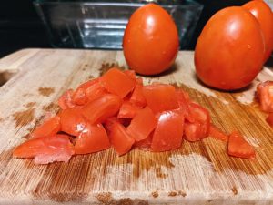 Dice Roma Tomatoes on Cutting Board