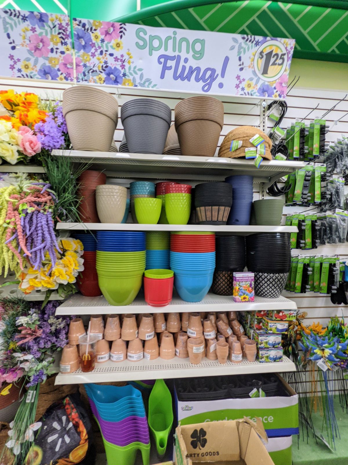 Colorful Spring Fling gardening supply setup at Dollar Tree in February 2022