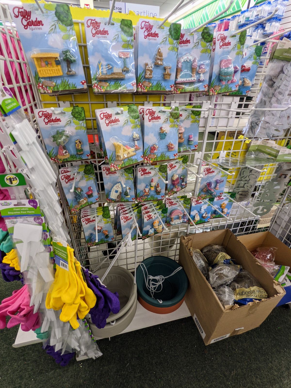 Rack of fairy garden characters and supplies at Dollar Tree in March 2023