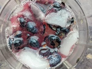 Muddled Blueberries with Crushed Ice in a Rocks Glass