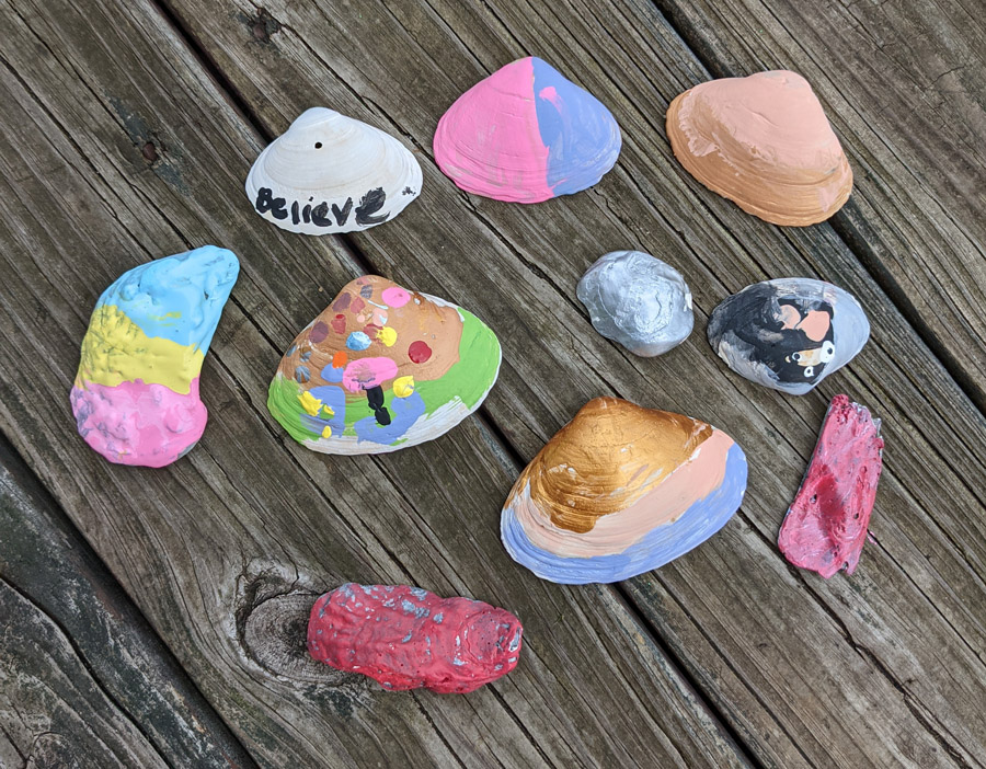 DIY Kids Gardening Craft - Shell Garden Markers in lots of pretty colors on a wooden deck