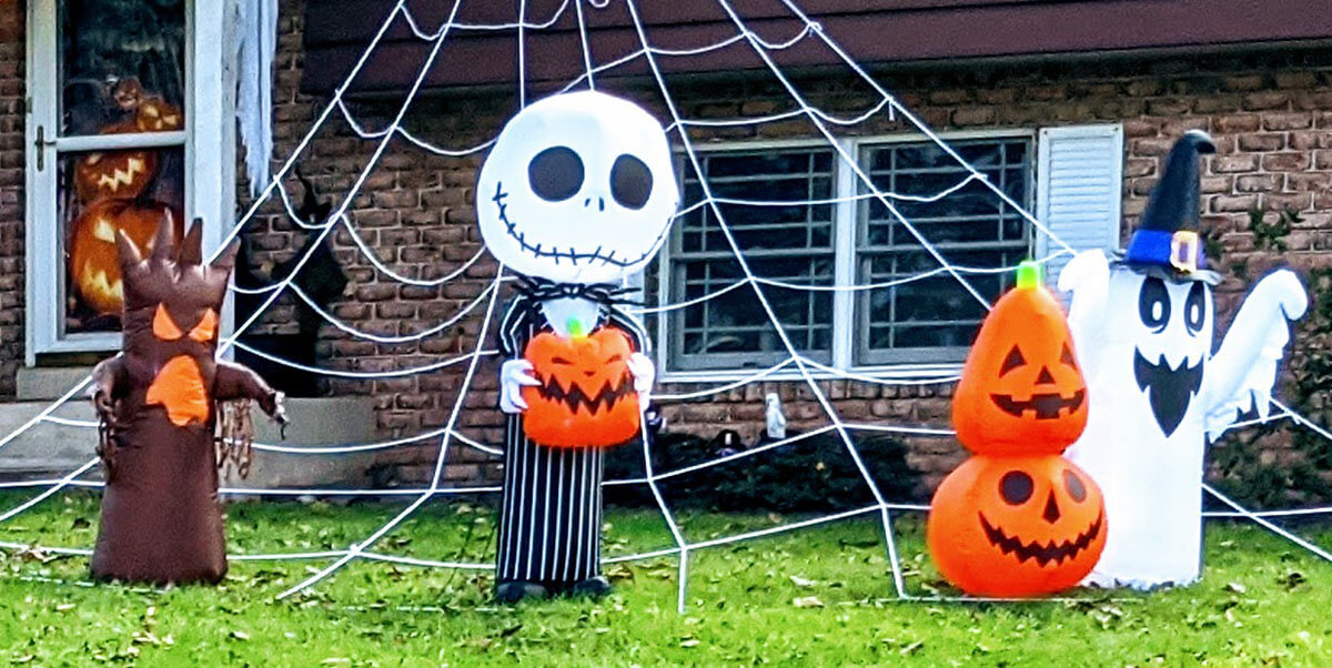 Halloween Garden with Spiderweb in front with spooky characters and decorations in back