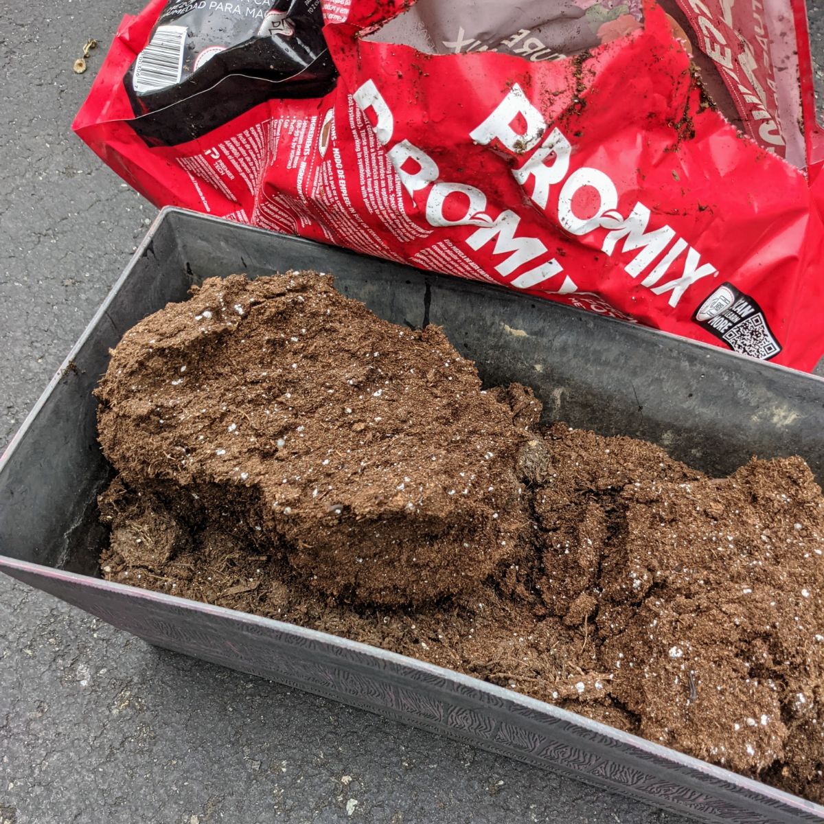 Pro Mix compressed potting soil moisture mix in the pink bag poured into a rectangular planter