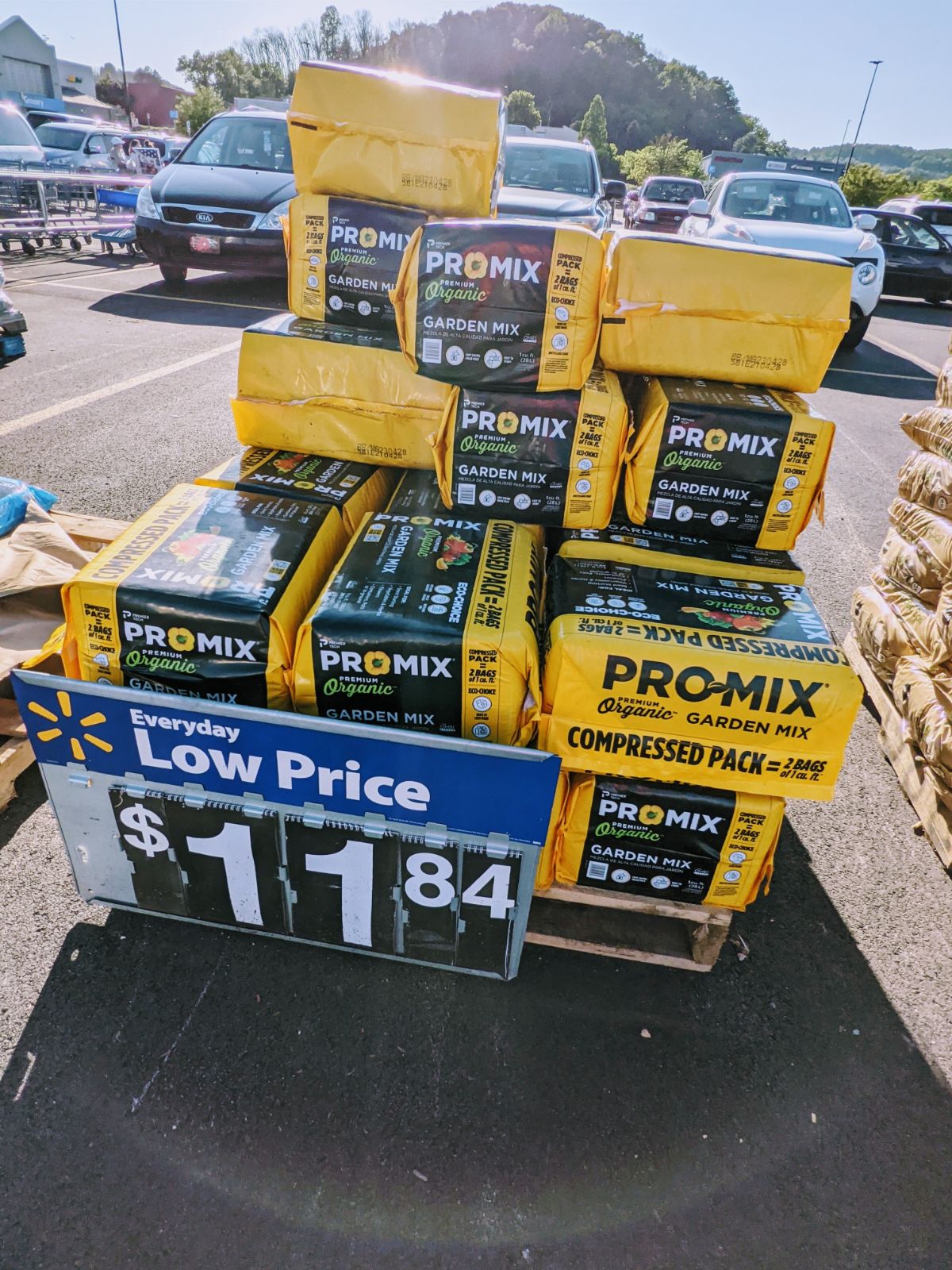 Yellow bag of Pro Mix organic soil for sale in the parking lot at Walmart in June 2022