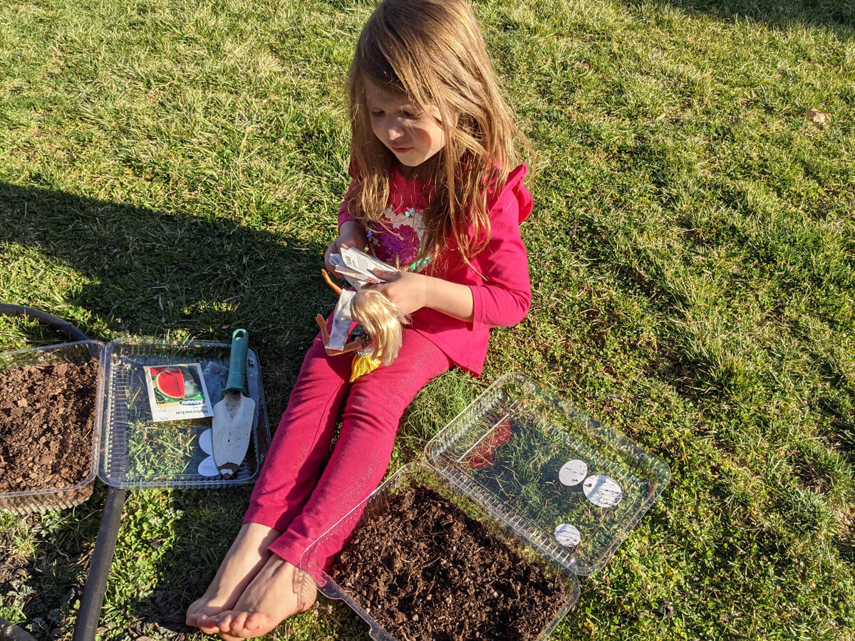 Daughter starting seeds in plastic containers for winter sowing