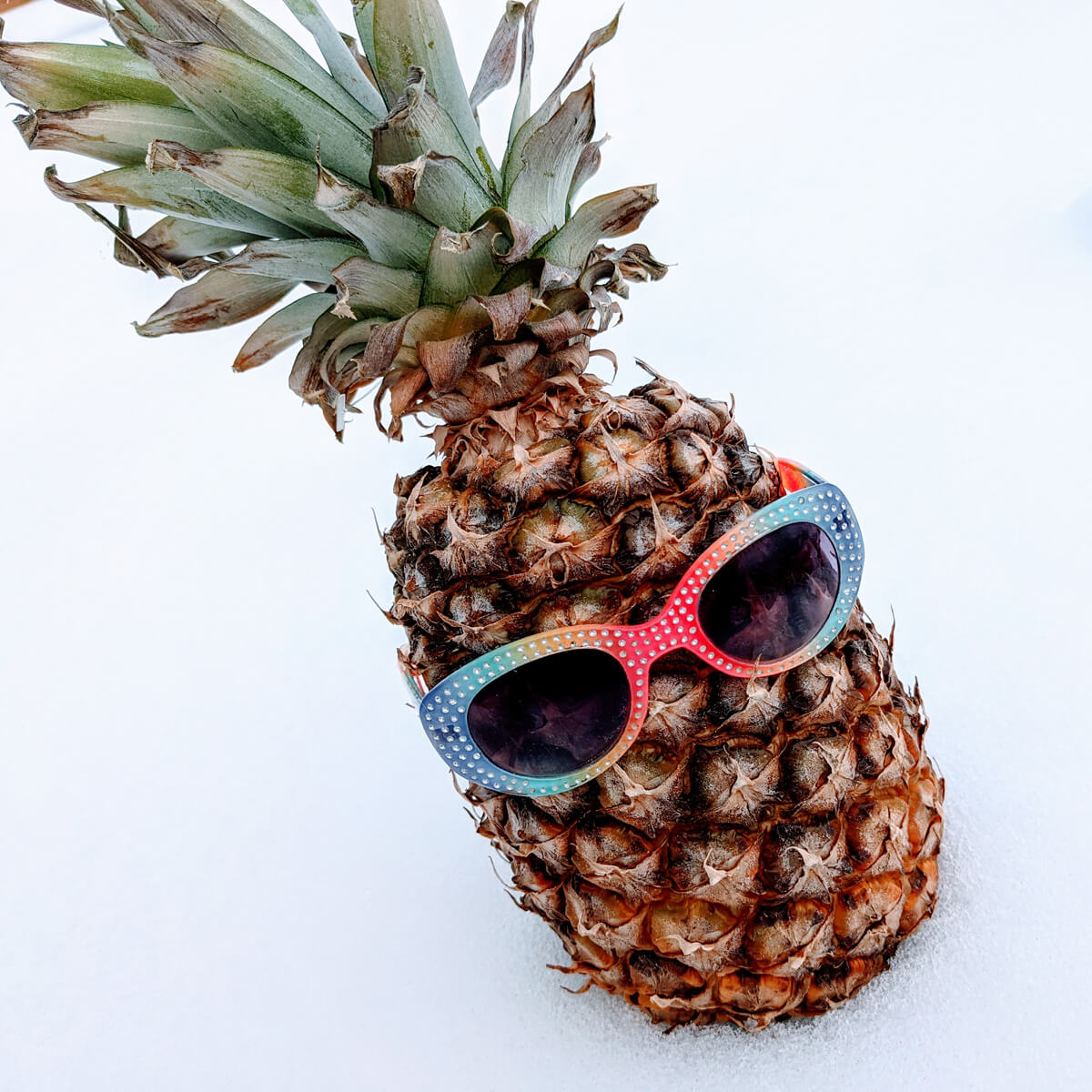 Pineapple in the snow wearing sunglasses - ripe pineapple!