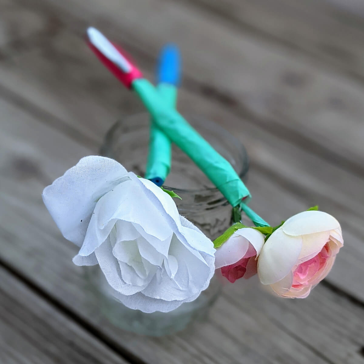 Create gorgeous Flower Pen Roses with tape, pens, and fake flowers.