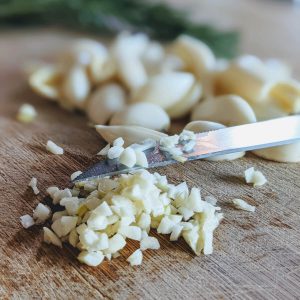 Minced Garlic on a bamboo cutting board