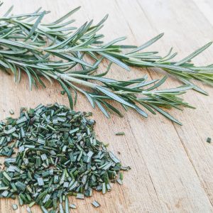 Minced Rosemary on a bamboo cutting board