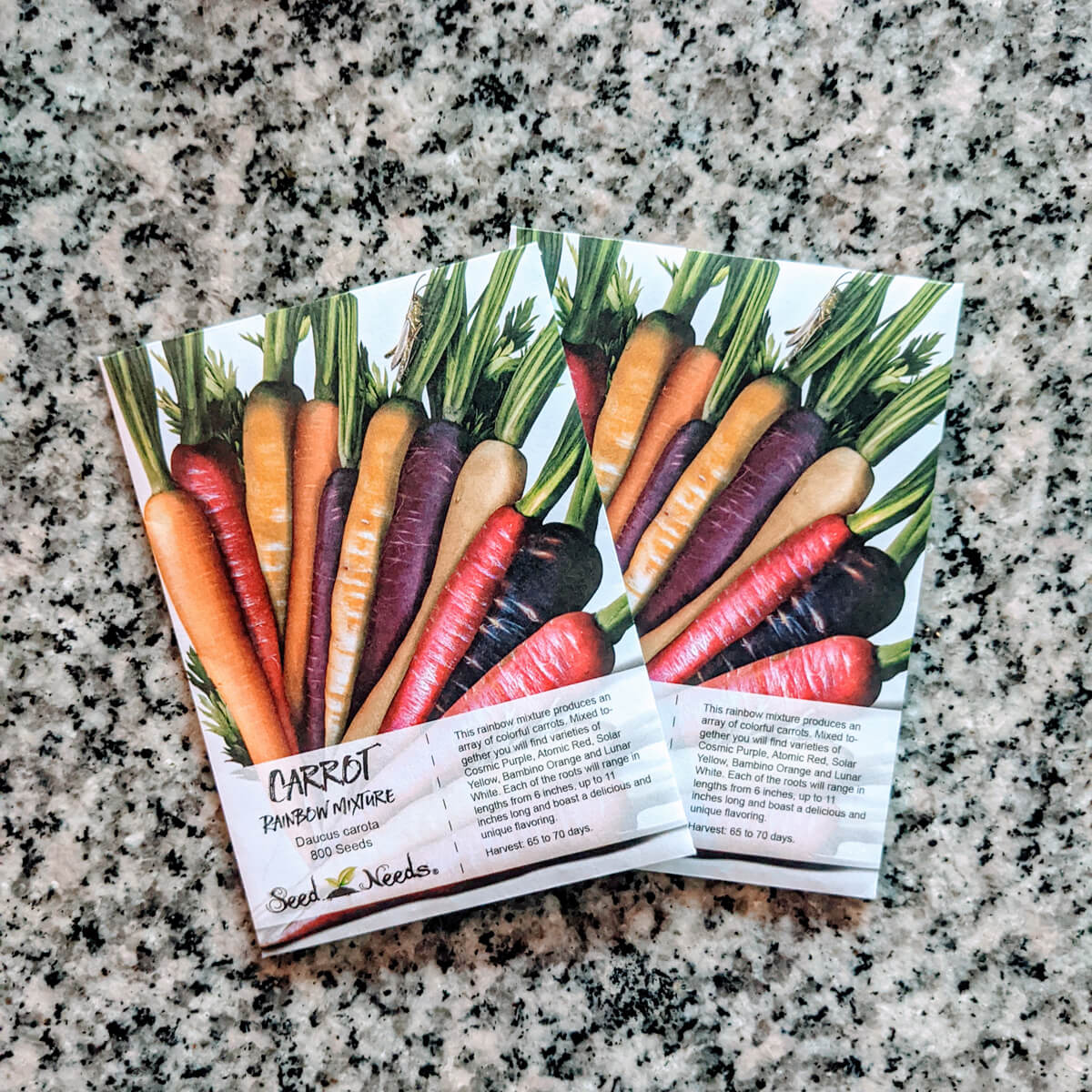 Rainbow Carrots Seed Packets on Granite Table