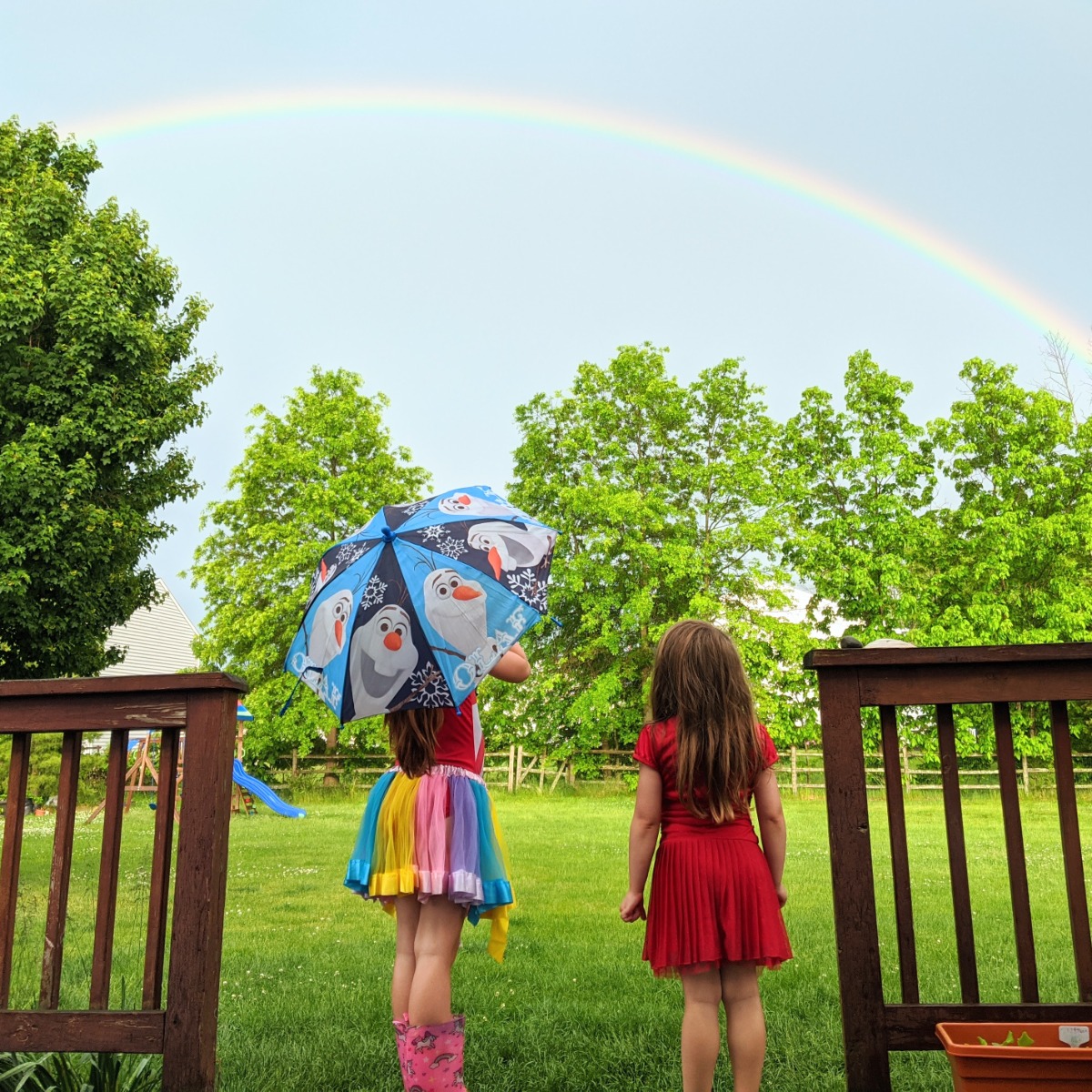 Girls hanging outside by the garden after a rain storm