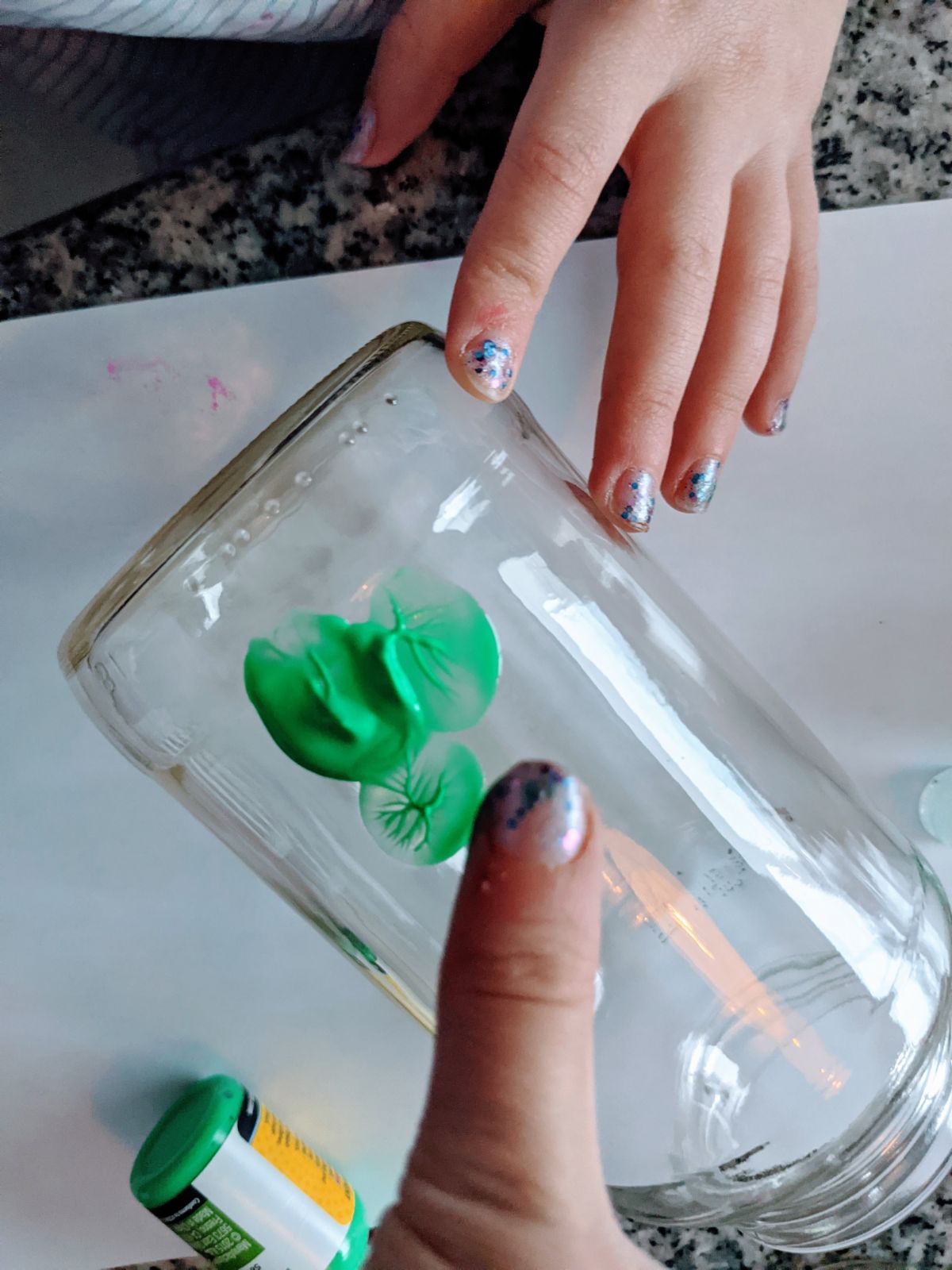 Child's hands making a Shamrock Thumbprint Vase / Flower Jar