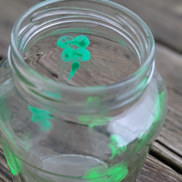 Thumbprint four-leaf clovers on clear glass jars made as shamrock vases
