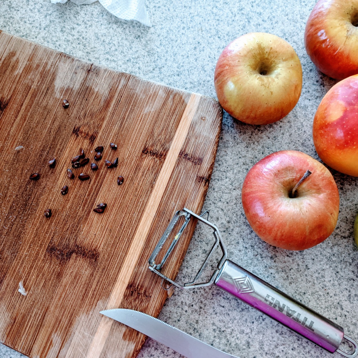 Apple Seeds Removed from Apples with a Cutting Board, Knife, and Peeler