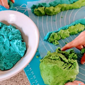 Pinches of blue and green cookie dough to create Earth Day Cookies