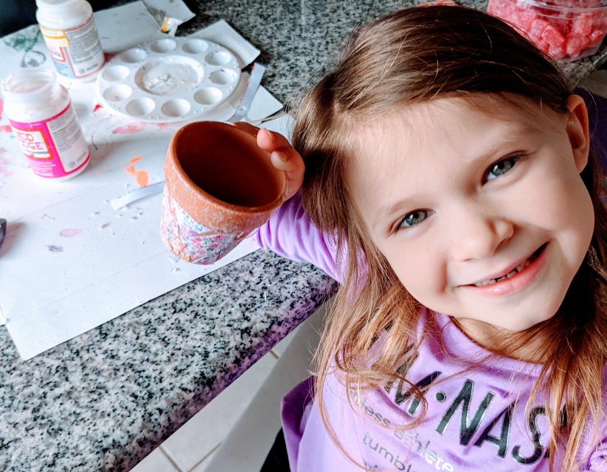 Fun and easy kids decoupage craft with clay flower pot, paper, and Modge Podge