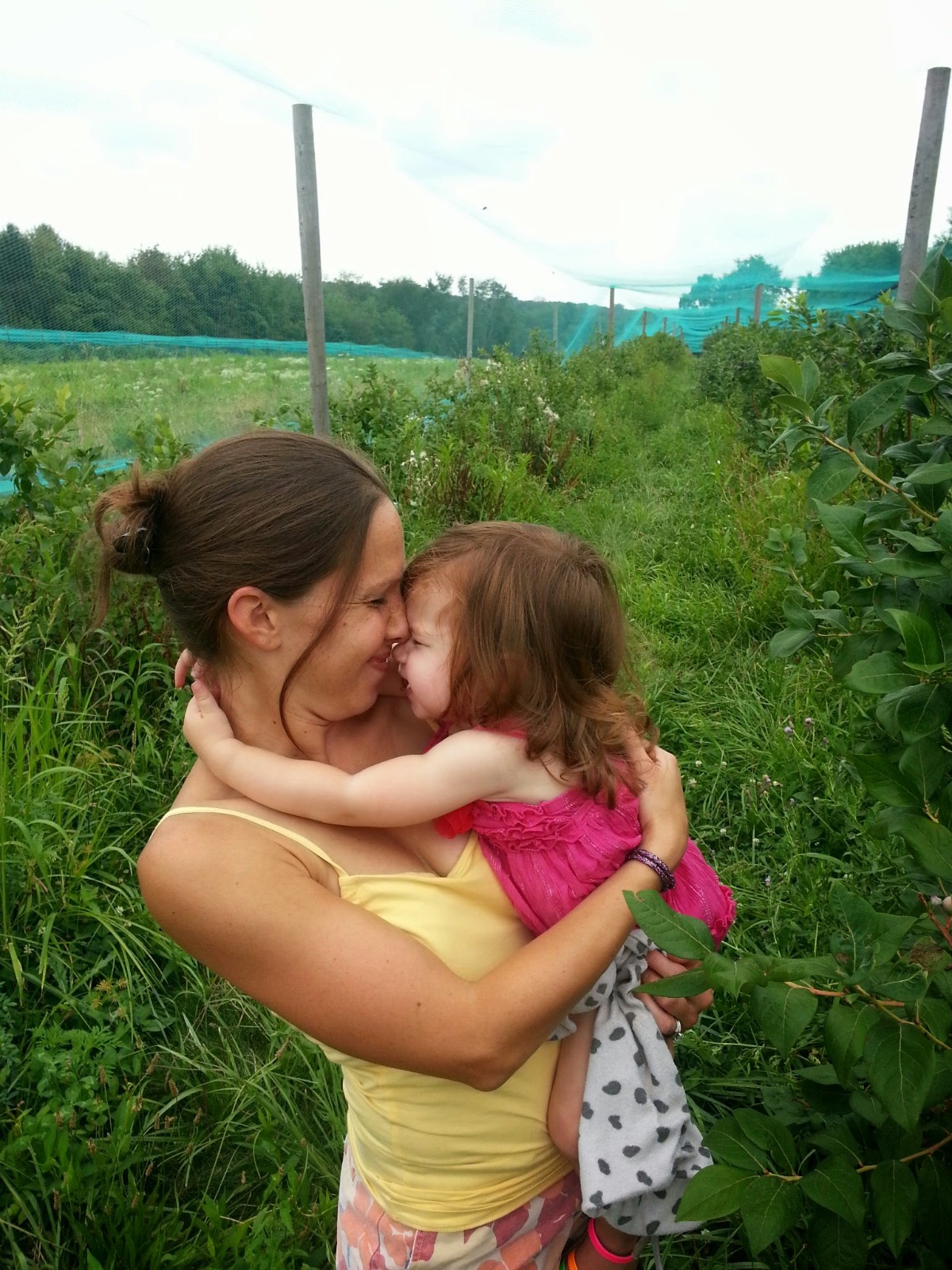 Mom and daughter under the Blueberry Netting in 2014 blueberry picking adventure