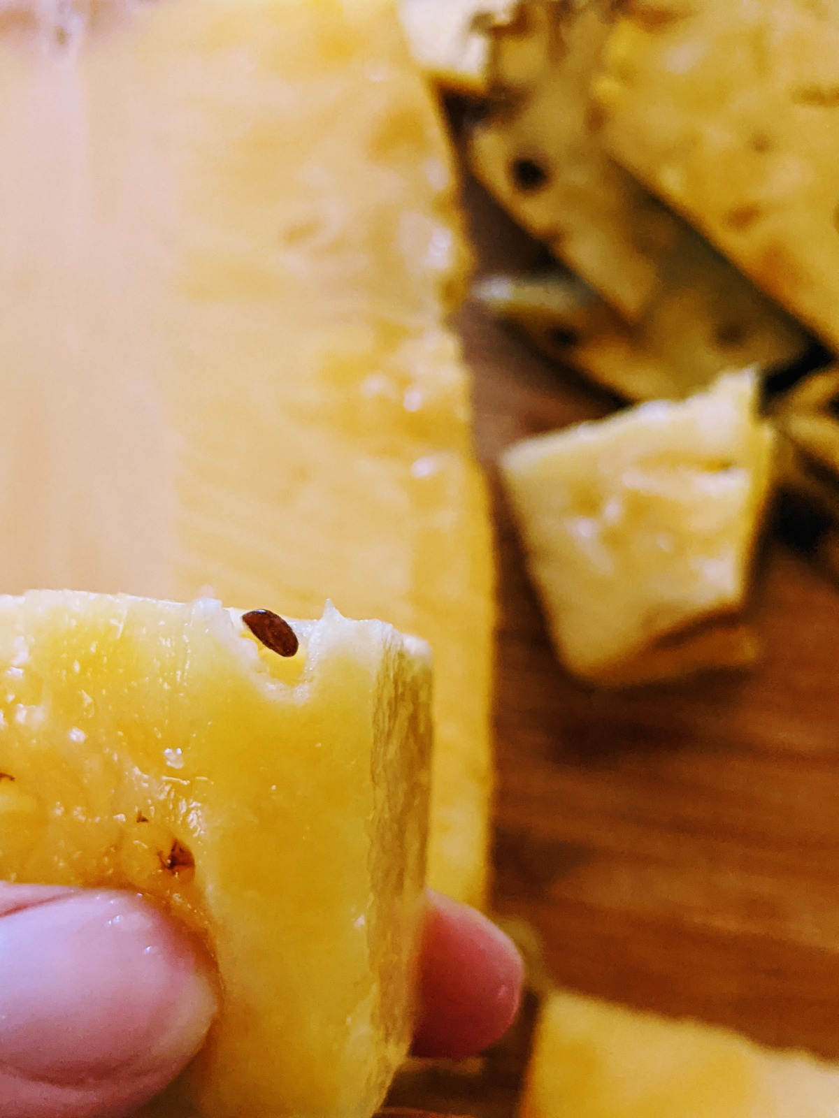 Pineapple seed on a fresh wedge of pineapple