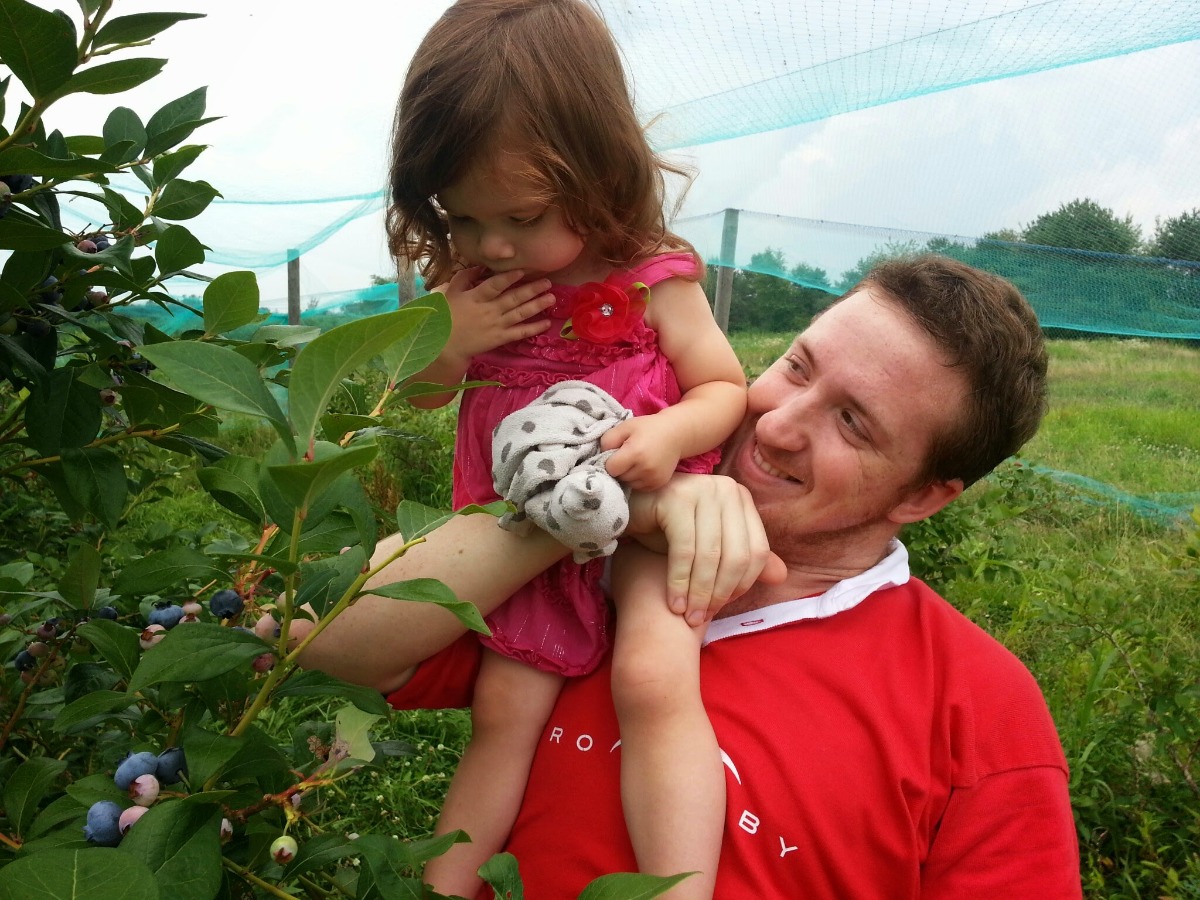 Cute pic of my brother and my oldest daughter at a fun berry picking outing in 2014, under the blueberry nets