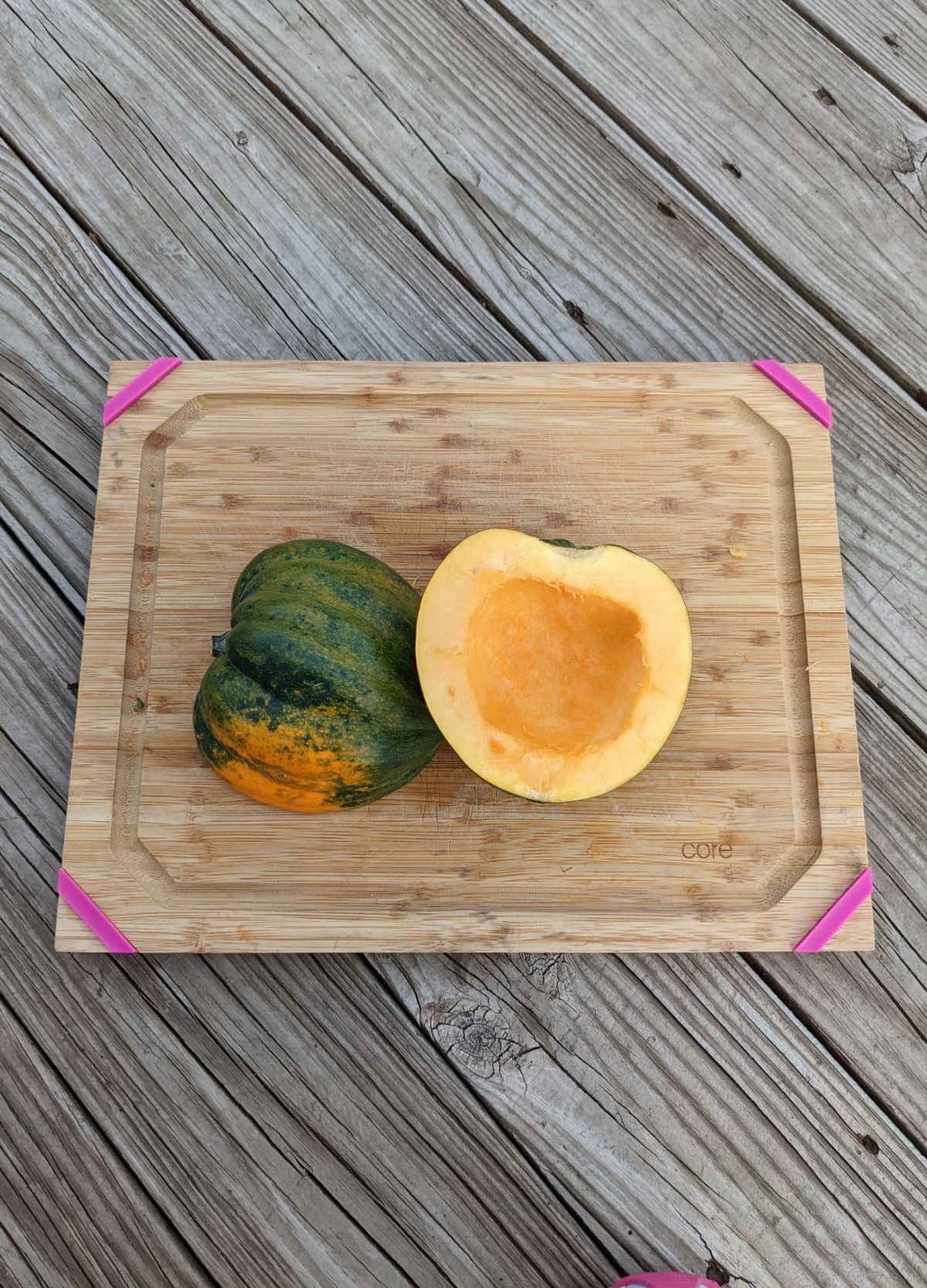 Acorn squash cut in half on a cutting board