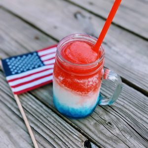 Red White and Blue Layered Drink - Frozen with straw in a mug, and flag