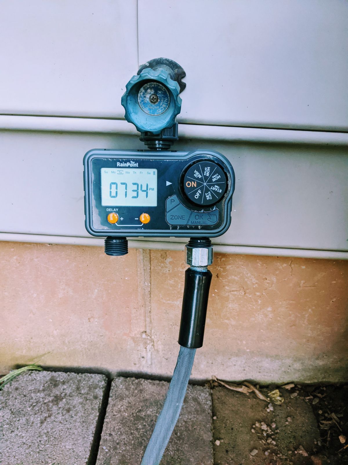 Rainpoint hose timer with a soaker hose for vacation watering schedule