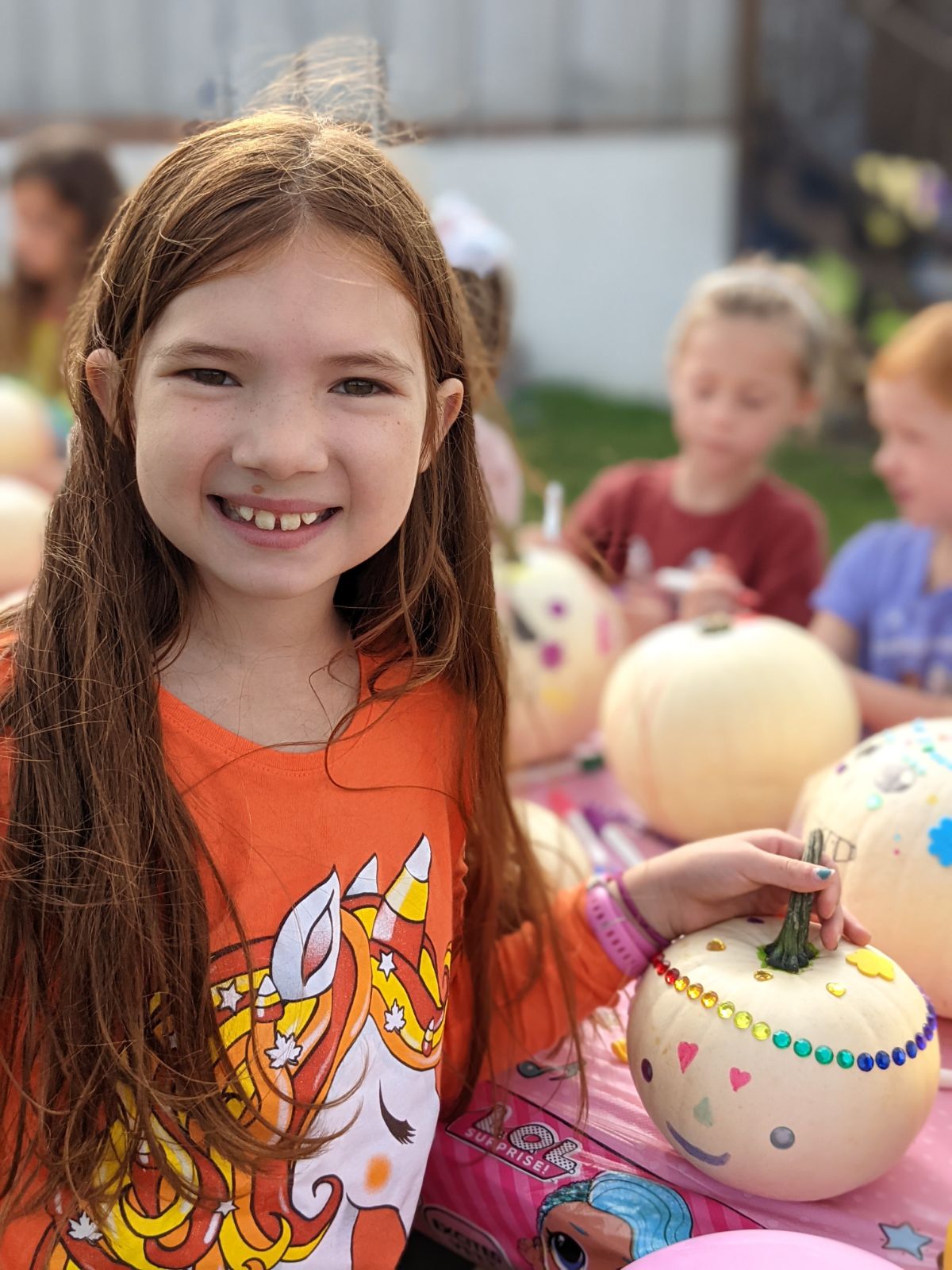 Older daughter decorated a white pumpkin like a sugar skull