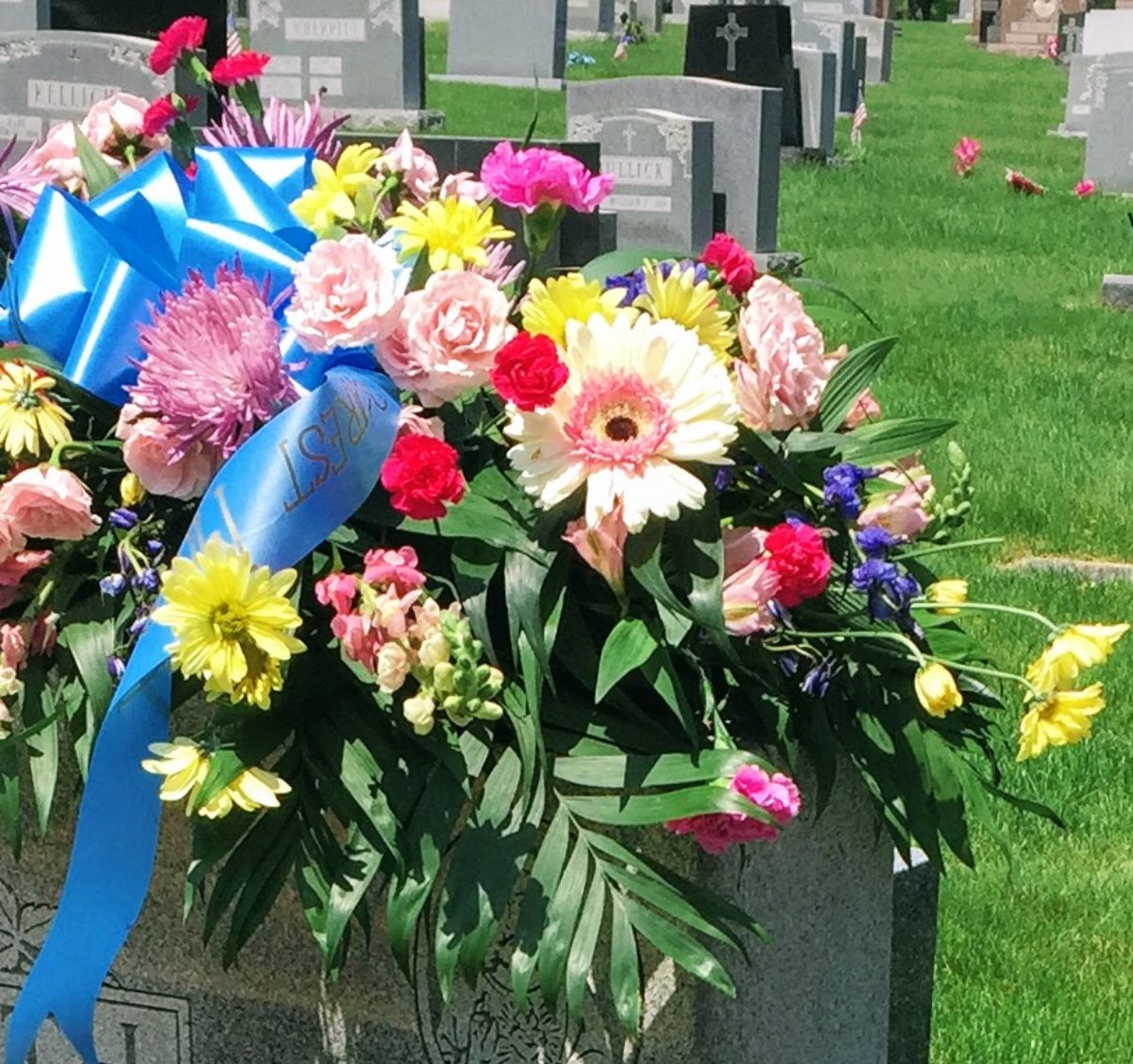 Funeral flowers on a sunny day at the cemetery