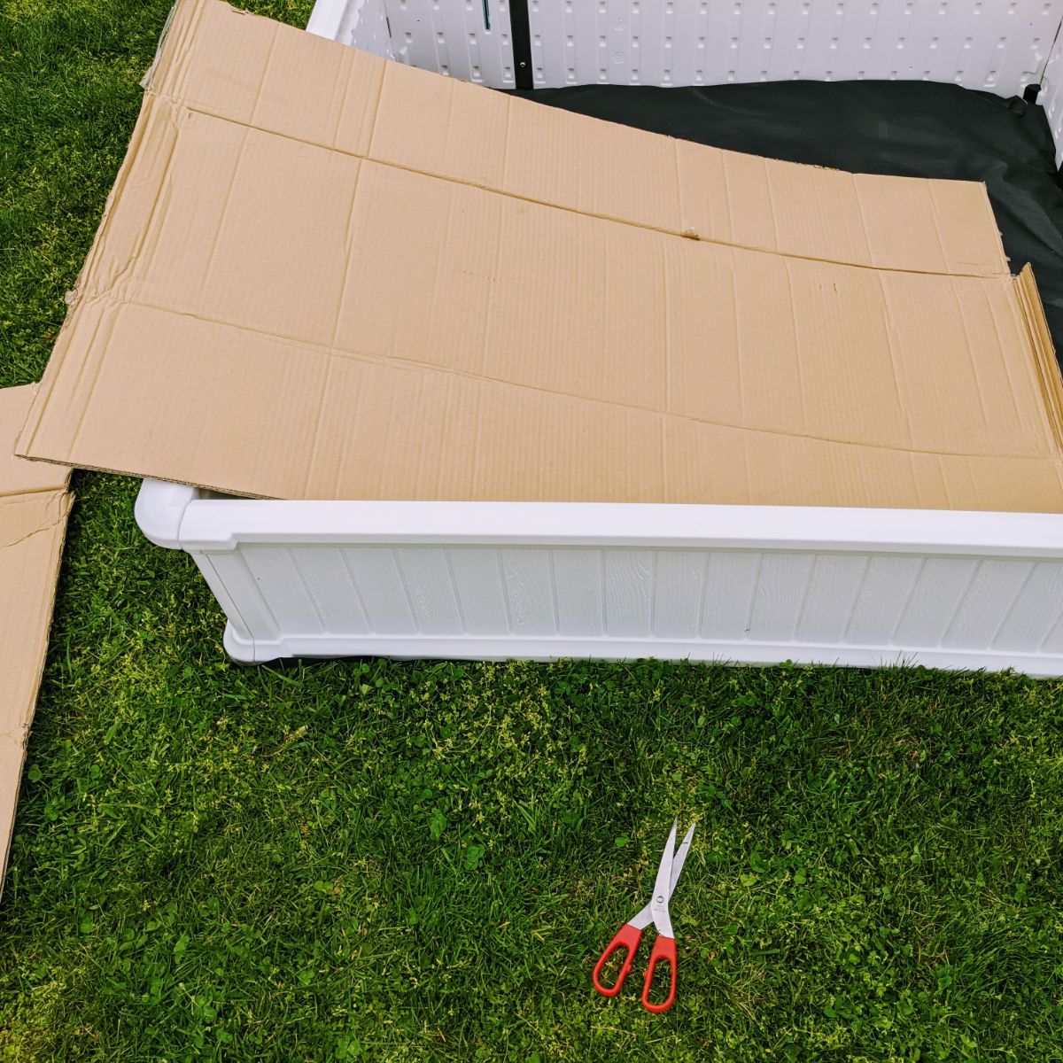 Cutting cardboard for a garden box barrier