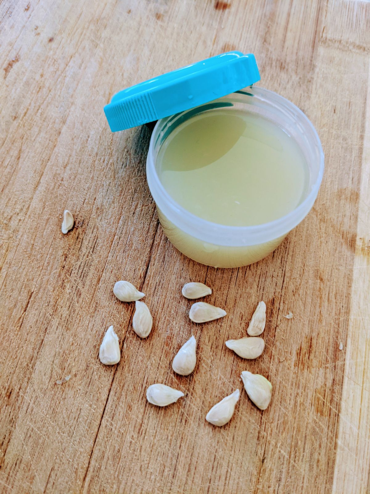 Key lime juice and many seeds on a cutting board