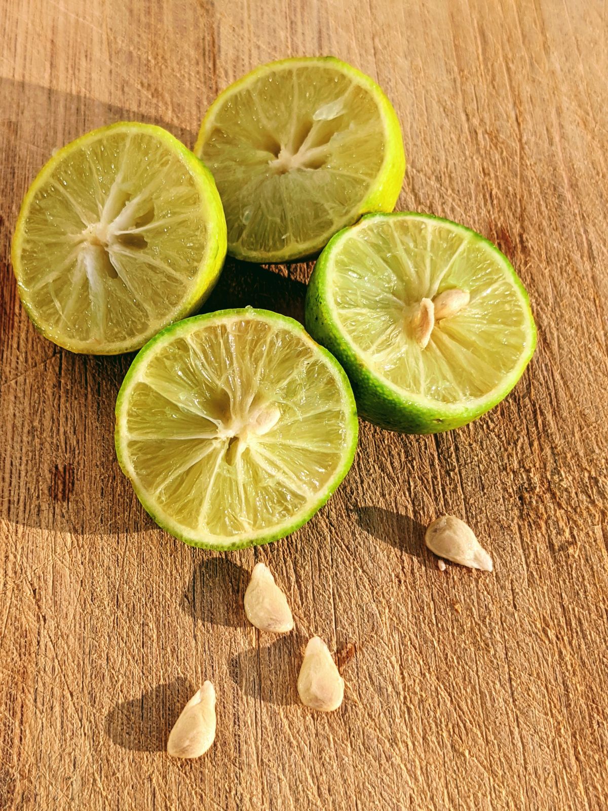 Sliced limes with seeds on a cutting board