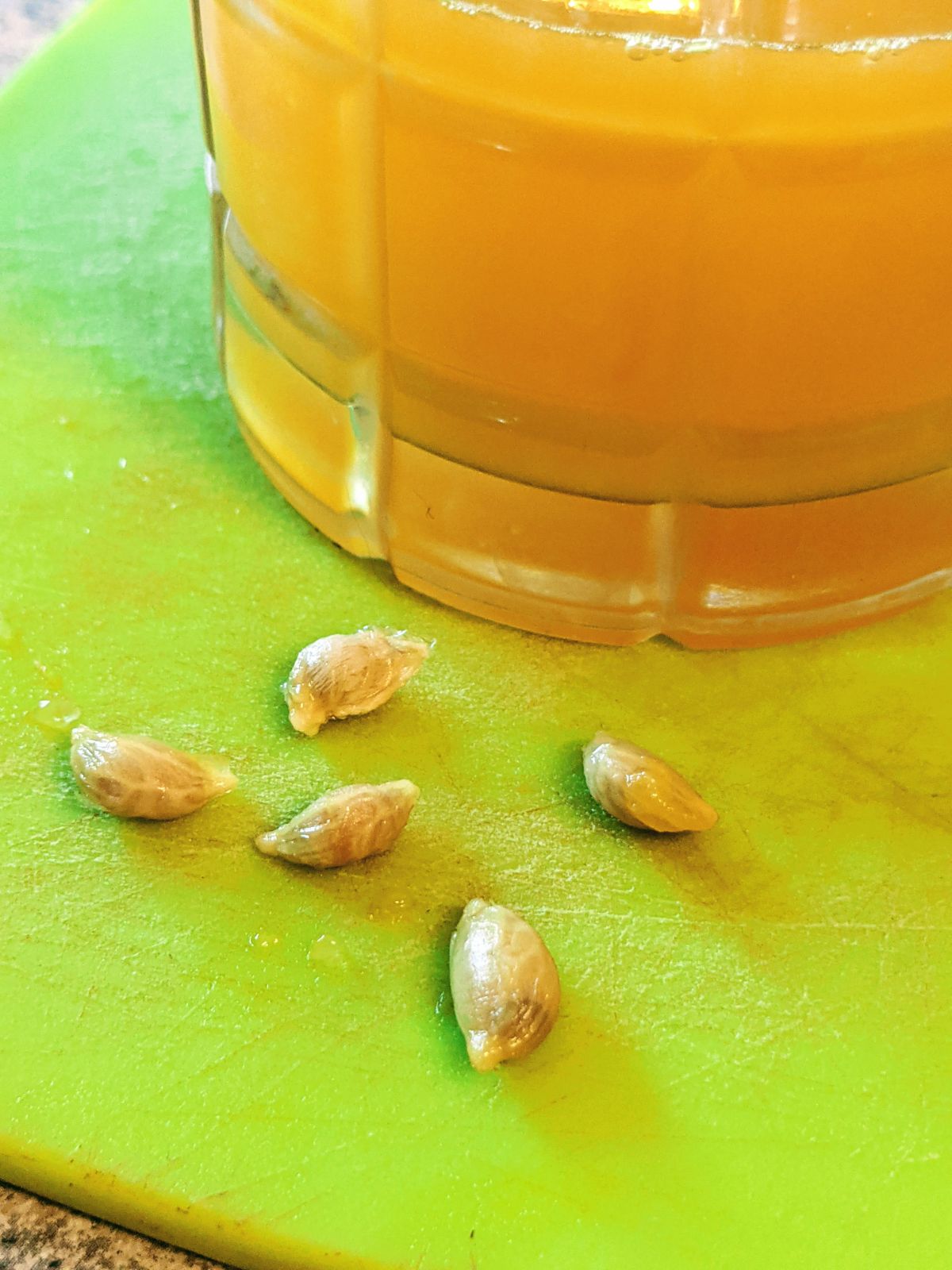 Orange juice with seeds on a cutting board