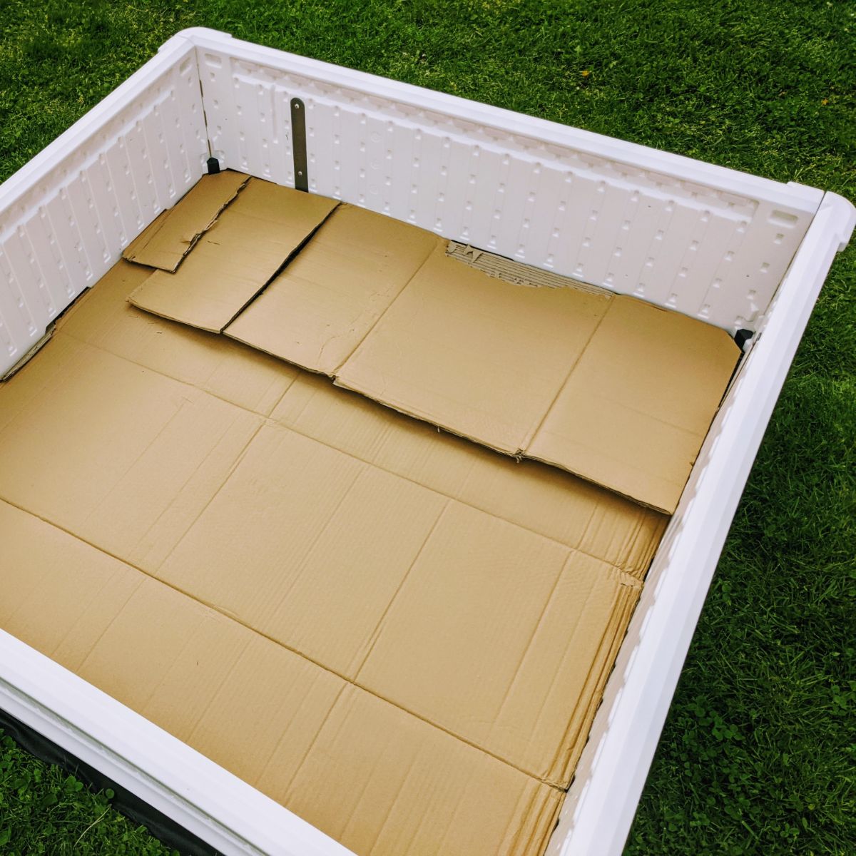Layer of cardboard on the bottom of a Giantex raised garden bed