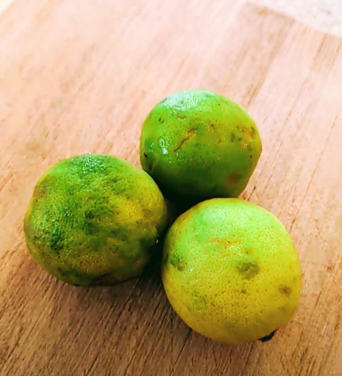 Trio of key limes on a cutting board