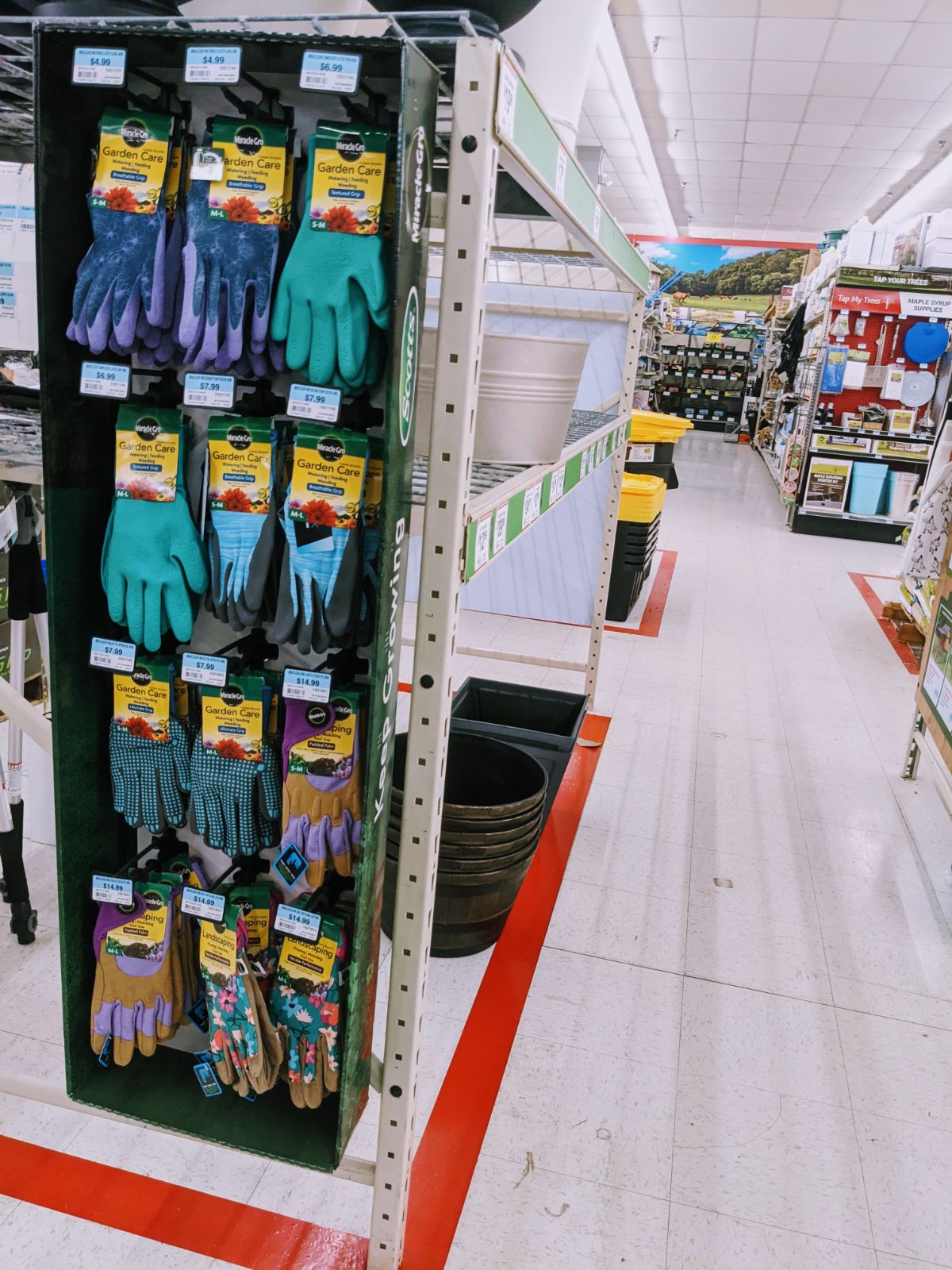 Aisles in Tractor Supply with garden gloves and planters