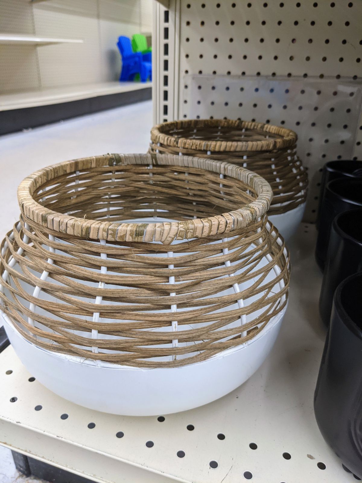 Boho style planters with white base and woven wicker in neutral tones