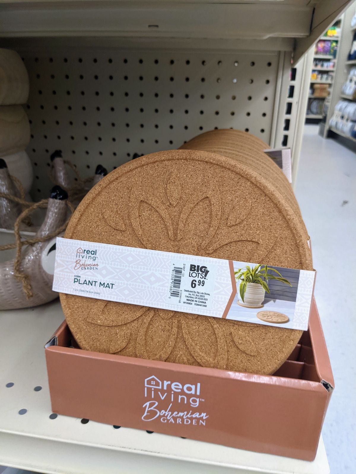 Cork plant mat with a flower in the center for sale in Boho garden section at Big Lots