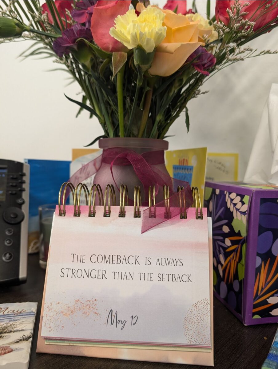 Positive calendar statement with a bouquet on a deck at work